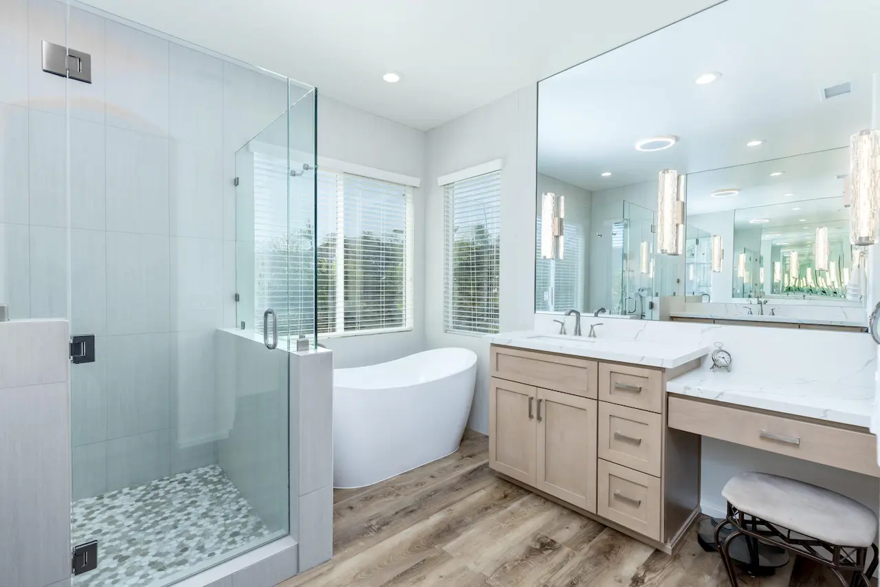 Scripps Ranch bathroom remodel featuring glass enclosure, pebble tile and built-in makeup vanity