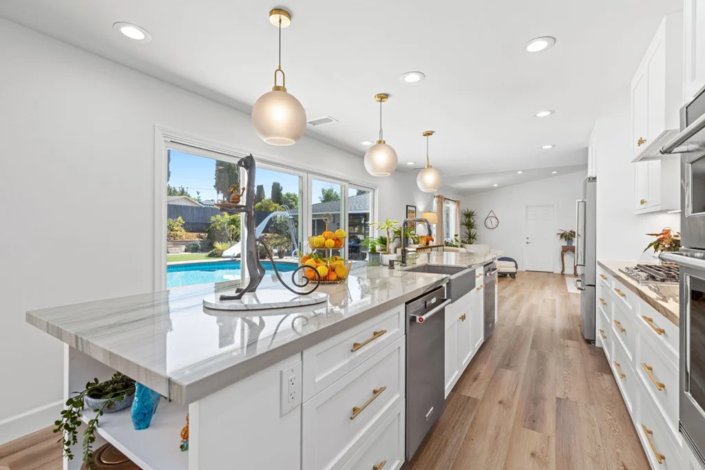 Teknik Design & Remodeling: San Diego kitchen remodeling with pool view and white cabinets