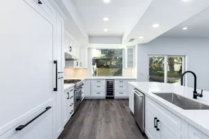 Luxury remodeled kitchen; white shaker cabinets with black rectangular hinges and chrome appliances